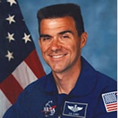 Photo of NASA astronaut Duane Carey with American flag